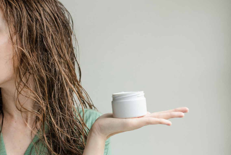 Woman holding a product for branded social media content by Ivelis Social Agency